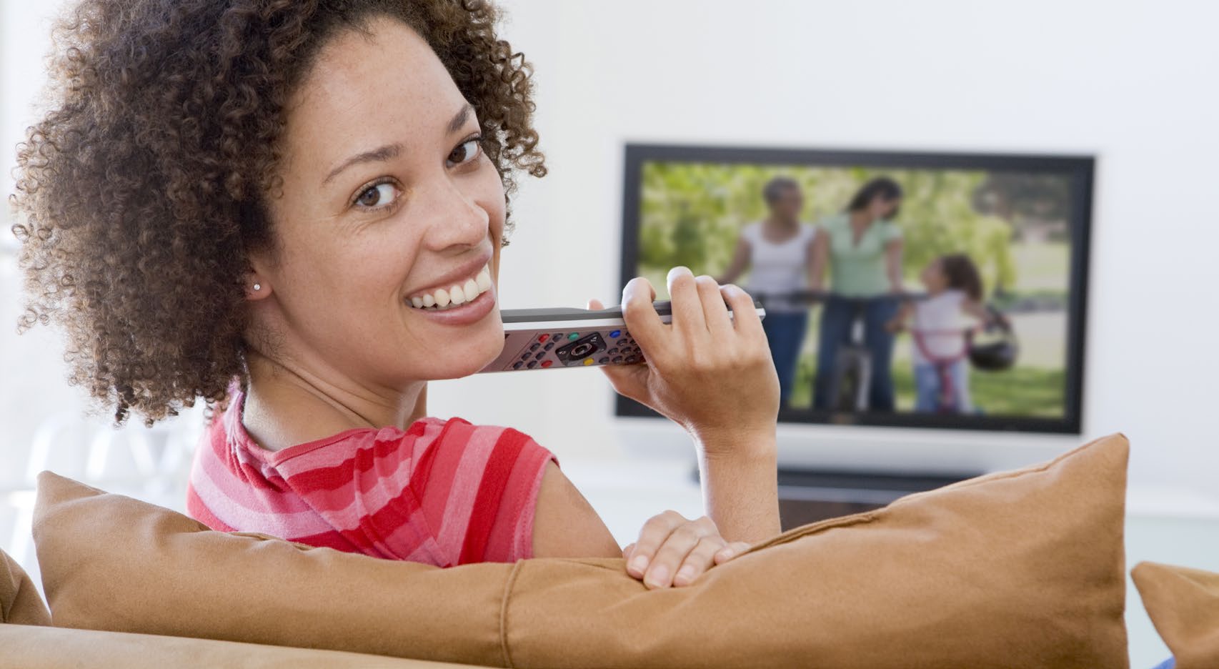 Woman watching TV Woman smiling and watching TV