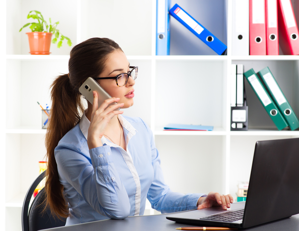 Woman working behind computer Woman working behind computer