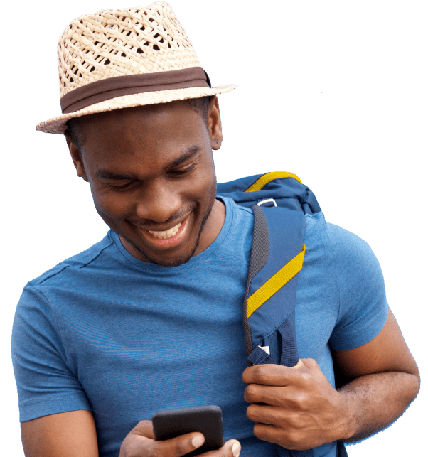 man wearing a fedora and backpack checks his phone