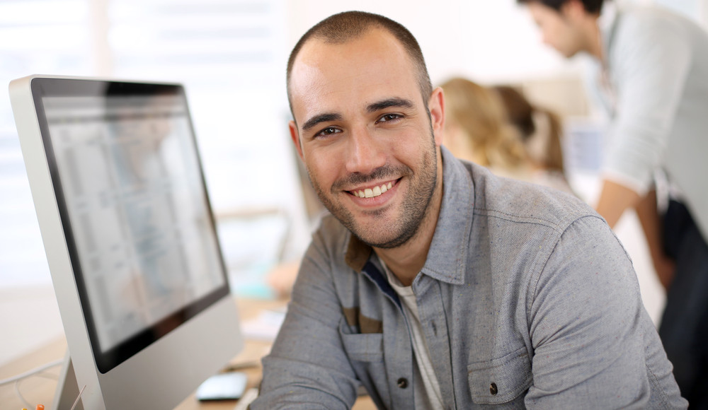Sales guy behind a computer