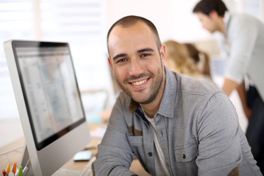 Sales guy behind a computer Sales guy behind a computer