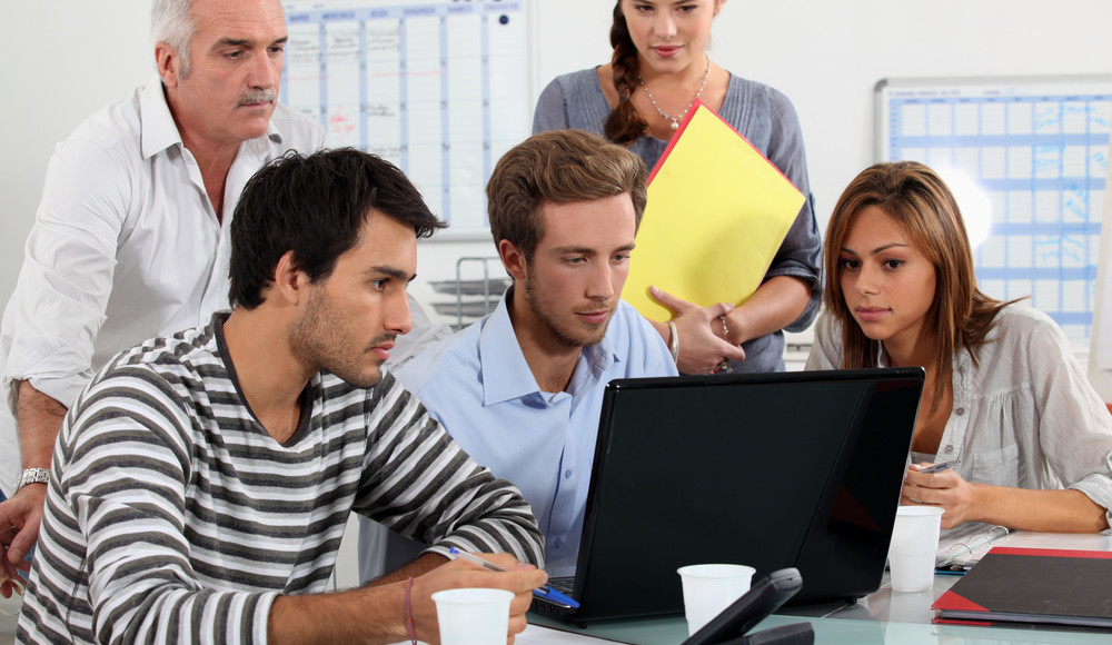 Team looking at computer
