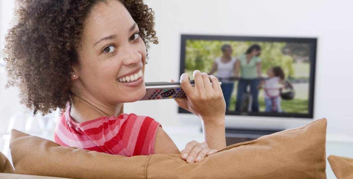 Woman smiling and watching TV