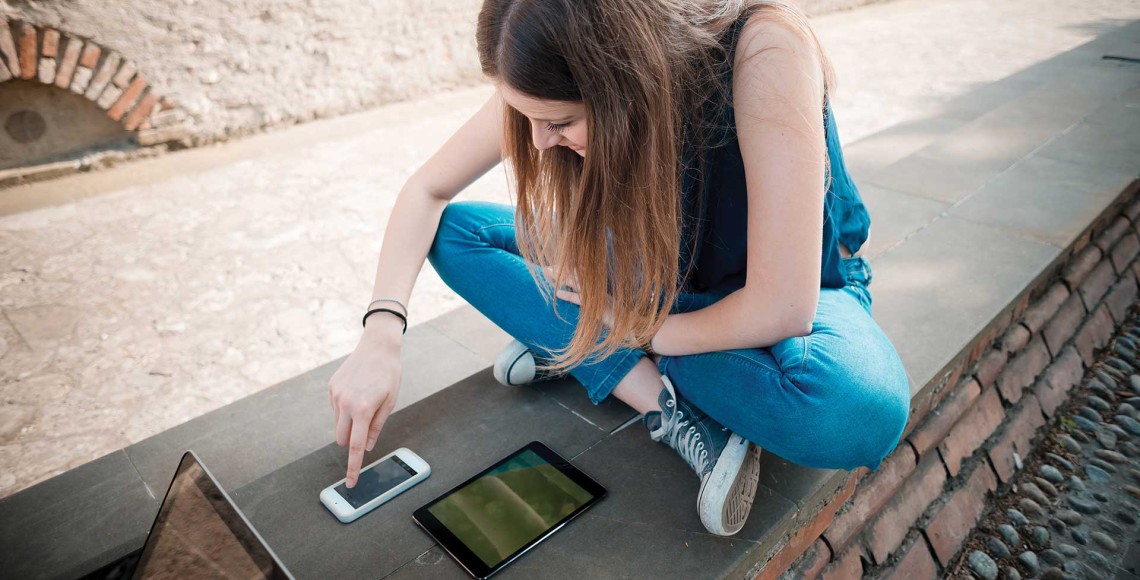 Girl using a phone and tablet