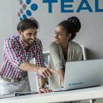 Two team members working together at Tealium
