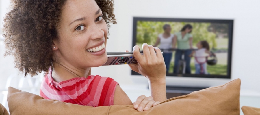 Woman smiling and watching TV