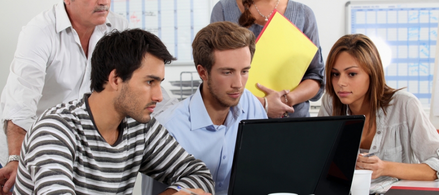 Team looking at computer